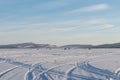Traces of cars created patterns on the white snowy space of the frozen Big Lake. ÃÂ  Royalty Free Stock Photo